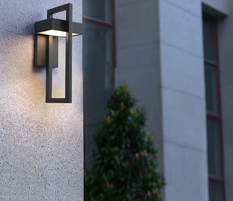 Rectangular black outdoor LED wall light on a stone facade
