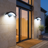 Curved outdoor LED wall light on a house facade at dusk – view 9