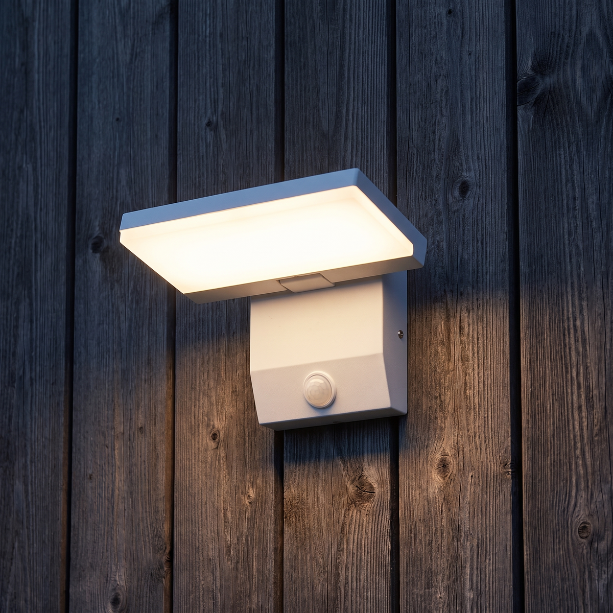 White outdoor LED wall light with motion sensor installed on dark timber