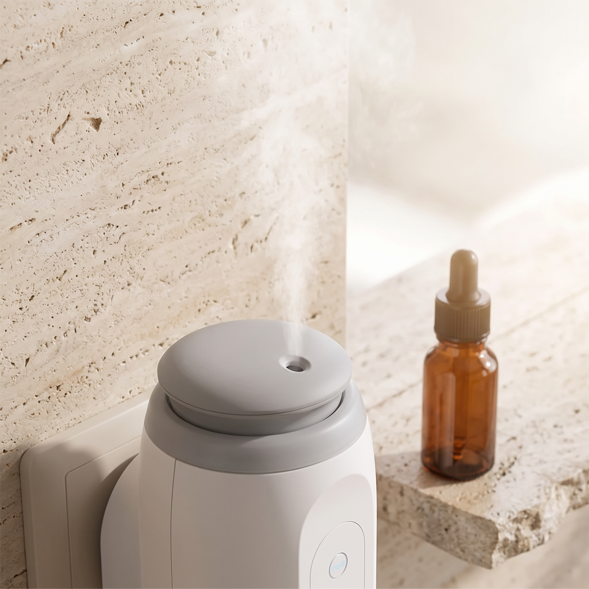 Fine cold-air mist from the diffuser, oil bottle beside it