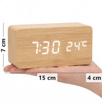 Bamboo wood-grain LED alarm clock in hand, 15 x 7 x 4 cm