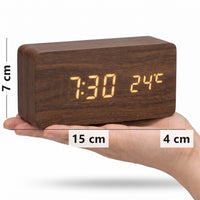 Brown walnut LED alarm clock in hand, 15 x 7 x 4 cm