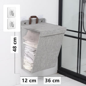 Grey wall-mounted folding laundry hamper, 48 x 36 x 12 cm, with adhesive hooks
